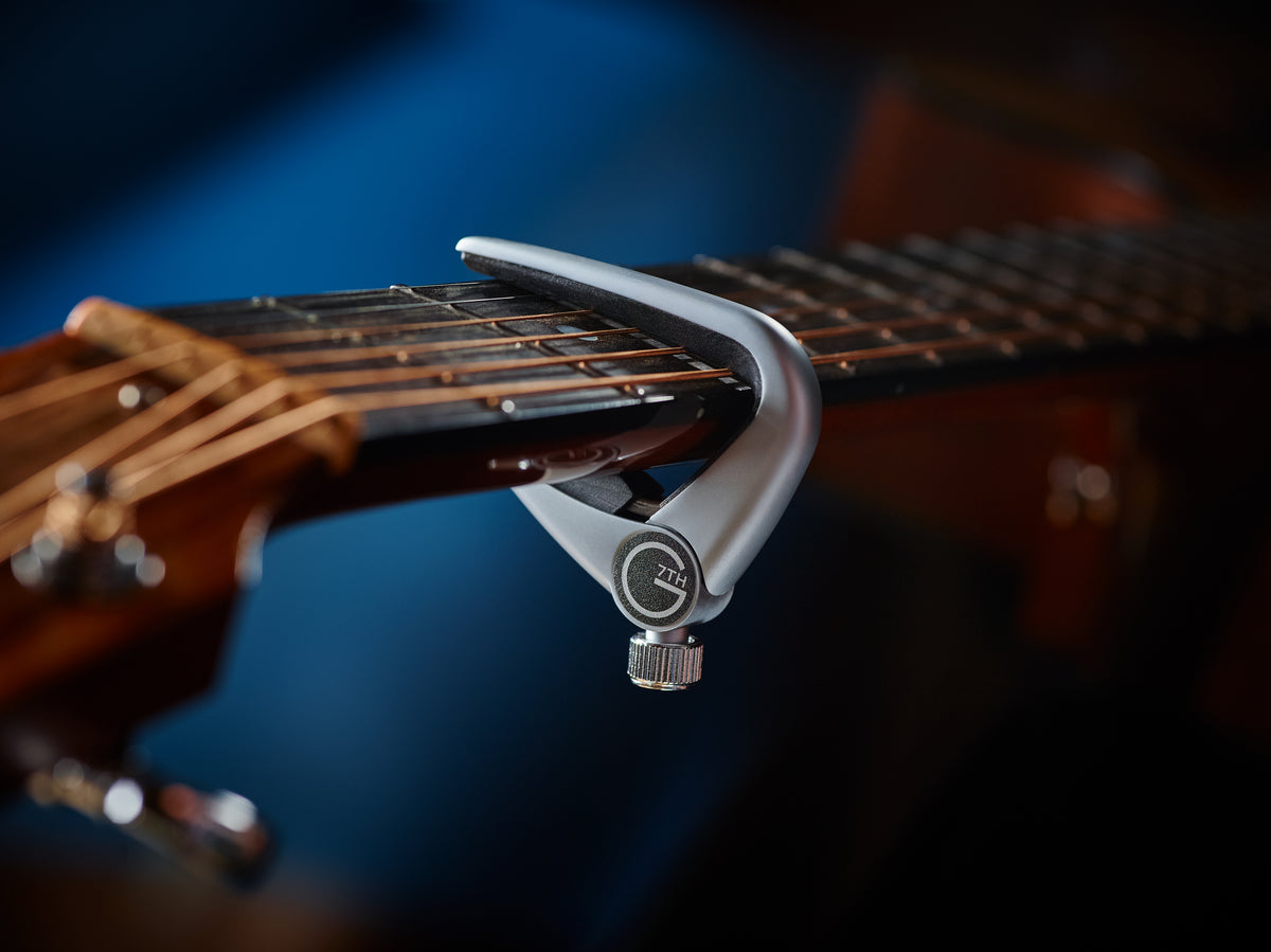 Close-up of the G7th Newport capo fitted on a guitar fretboard